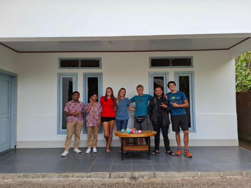 a group of people standing in front of a house at De PO'ONG in Ruteng