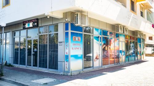 a store front with glass doors on a street at Hotel Kapsul Vlore in Vlorë