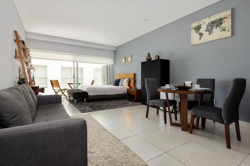 a living room with a couch and a table at Alure Condesa in Mexico City