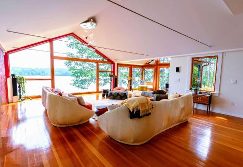 a living room with two couches and a large window at The Lodge at Seaside in Friendship in Friendship