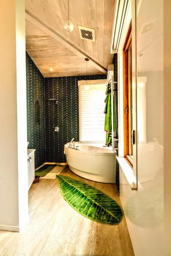 a bathroom with a large leaf rug on the floor at The Lodge at Seaside in Friendship in Friendship