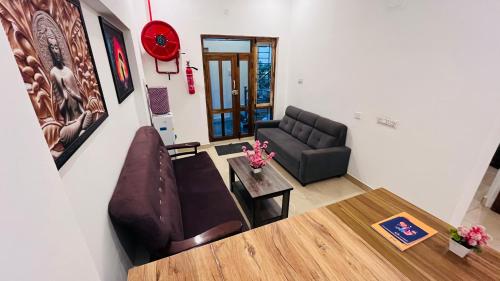 a living room with a couch and a table at The Chalet - Cozy Villa with Mini Pool, near Eden Blue Flag Beach, Pondicherry - JR Groups in Puducherry