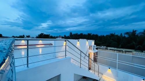 a view from the balcony of a building at night at The Chalet - Cozy Villa with Mini Pool, near Eden Blue Flag Beach, Pondicherry - JR Groups in Puducherry