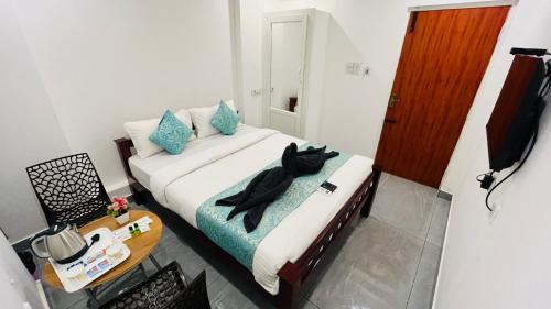 a small room with a bed and a table at The Chalet - Cozy Villa with Mini Pool, near Eden Blue Flag Beach, Pondicherry - JR Groups in Puducherry