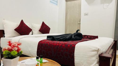 a hotel room with two beds with a swan on the bed at The Chalet - Cozy Villa with Mini Pool, near Eden Blue Flag Beach, Pondicherry - JR Groups in Puducherry