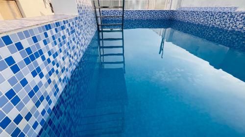 a swimming pool with a ladder in the water at The Chalet - Cozy Villa with Mini Pool, near Eden Blue Flag Beach, Pondicherry - JR Groups in Puducherry