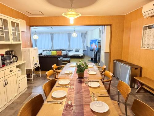 a dining room with a long table and chairs at M-Haneda Lex Apartment 137sqm 3BDR Max24 PPL 1min from Sta FreeParking in Tokyo