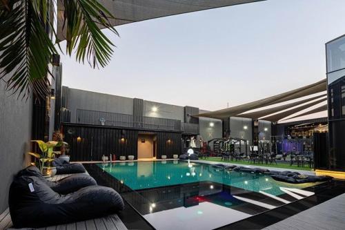 a large swimming pool with pillows in a building at 2BR Modern & Comfy Apartment in luxury neighbourhood in Madinaty