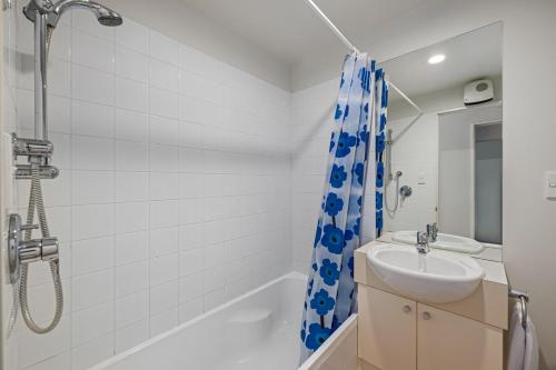 a bathroom with a sink and a shower at Marina Edge Marlborough Sounds Apartment in Waikawa
