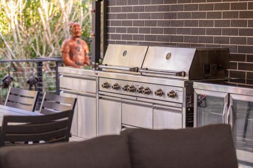 an outdoor grill with a statue in the background at Lizzie Bliss in Elizabeth Beach
