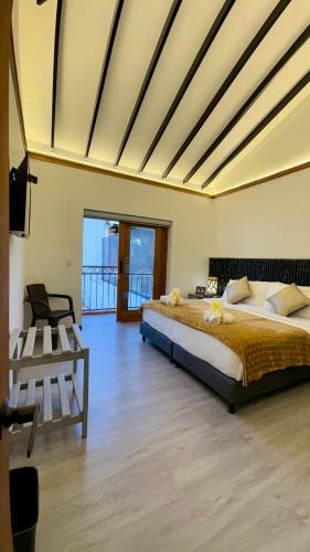 a bedroom with a large bed and a balcony at Hotel Boutique & Spa - VDL Colonial in Villa de Leyva