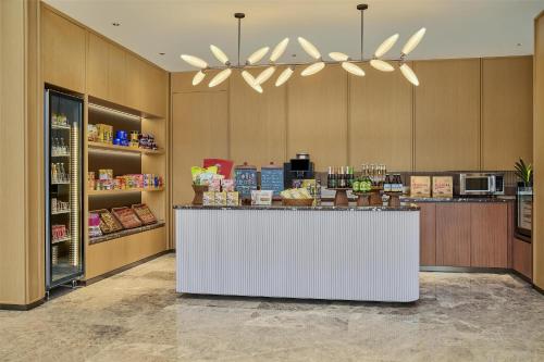 a store lobby with a white counter in a store at Hilton Garden Inn Chongqing Yubei Central Park in Chongqing