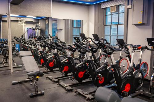 a gym with rows of exercise bikes in a row at Dover Marina Hotel & Spa, Tapestry Collection by Hilton in Dover