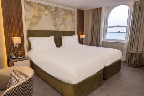 a hotel room with a large bed and a window at Dover Marina Hotel & Spa, Tapestry Collection by Hilton in Dover