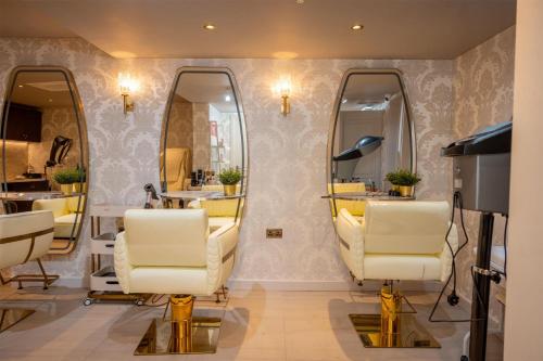 a salon with two mirrors and two white chairs at Dover Marina Hotel & Spa, Tapestry Collection by Hilton in Dover