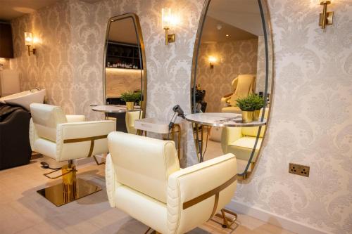 a salon with white chairs and a mirror at Dover Marina Hotel & Spa, Tapestry Collection by Hilton in Dover