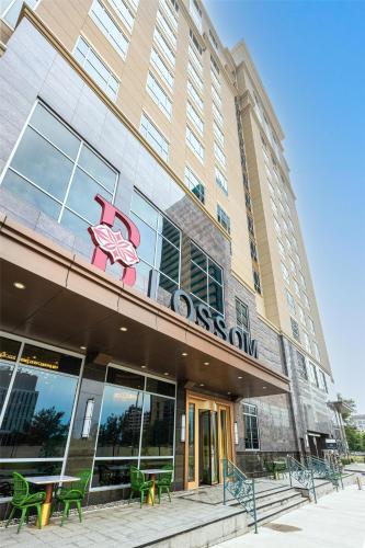 a building with a sign on the front of it at Blossom Hotel Houston, Curio Collection by Hilton in Houston