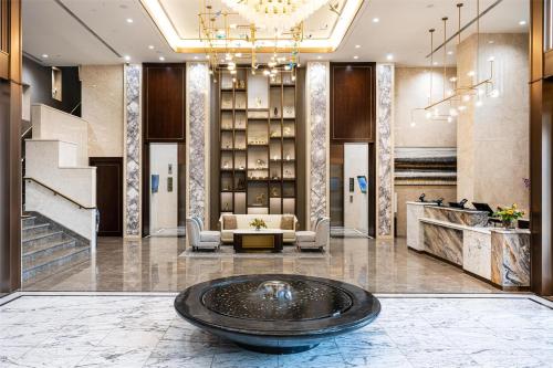 a lobby with a large fountain in the middle of a building at Blossom Hotel Houston, Curio Collection by Hilton in Houston