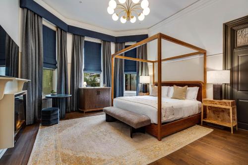 a bedroom with a canopy bed and a living room at White House Napa in Napa