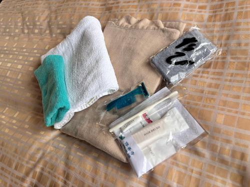 a pile of items sitting on a bed at Kinzan Villa in Izu