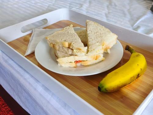a plate of sandwich and a banana on a tray at TN Travel Inn - Katunayake in Katunayake