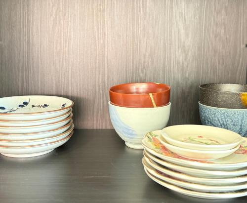 a group of bowls and plates sitting on a table at The YAMAGUCHI in Inzai