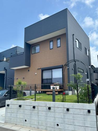 a house with a fence in front of it at The YAMAGUCHI in Inzai
