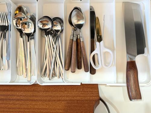 a drawer filled with silver utensils on a table at The YAMAGUCHI in Inzai
