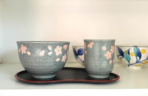 two vases are sitting on a tray on a table at The YAMAGUCHI in Inzai