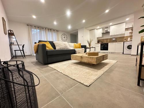 a living room with a couch and a table at App 4-6 Pers - Terrasse - Calme - Reposant in La Chambre