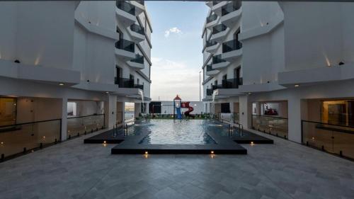 a large pool in the middle of a building at Sohob Compound in Al Khobar