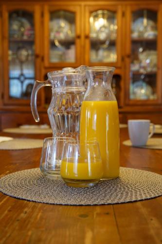 a glass jug of orange juice sitting on a table at Sabo’s On Severn in Fletcher