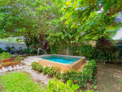 a swimming pool in the middle of a garden at Uvita Paradise in Uvita