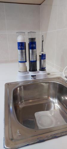 a bathroom sink with two bottles ofodorizers on top of it at Golden Kinabalu in Kota Kinabalu