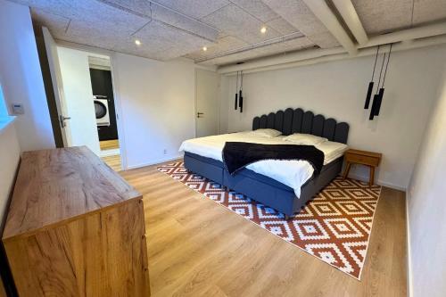 a bedroom with a large bed and a rug at Cozy & Modern Living in Central Odense in Odense