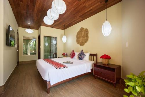 Postel nebo postele na pokoji v ubytování LuA House Hoian