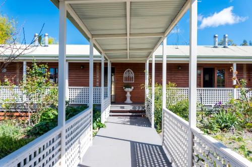 a porch of a house with a white fence at Sabo’s On Severn in Fletcher