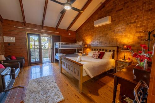 a bedroom with a bed and a brick wall at Sabo’s On Severn in Fletcher