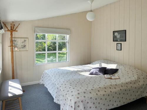 a bedroom with a bed and a window at Summerhouse Near Marielyst Beach With Large Garden in Marielyst