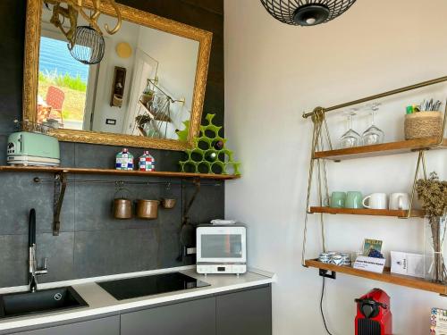 a kitchen with a sink and a mirror at Panoramic Villa In Madonie Natural Park in Pollina