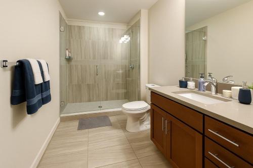 a bathroom with a shower and a toilet and a sink at Cozy Luxe Suite Rock Hall, Casino, Stadiums in Cleveland