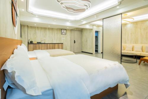 a bedroom with a large white bed and a couch at The Lu Village Retreat in Guilin