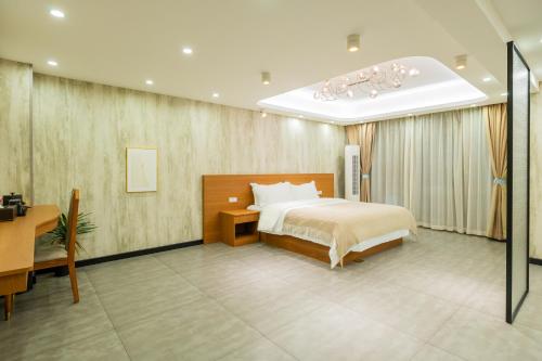 a hotel room with a bed and a table and a desk at The Lu Village Retreat in Guilin