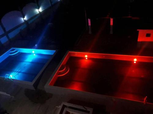 a pool table with red and blue lights on it at Palm Grove Saud Holiday Complex Hotel in Laoag