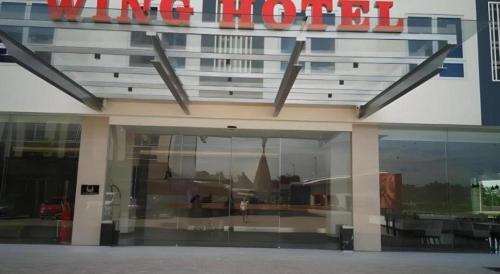 a building with a sign that reads wing hotel at Wing Hotel Kualanamu Airport in Medan