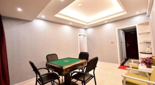 a room with a ping pong table and chairs at Dali Dayu Hotel in Dali