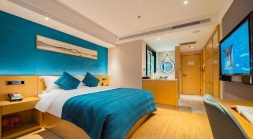 a bedroom with a large bed and a television at Xian Katie Eastman Hotel in Xi'an