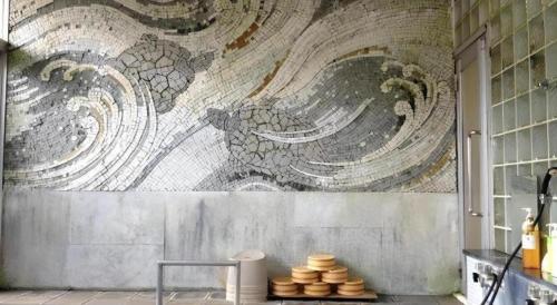 a kitchen with a mural on the wall at Kakeyu Onsen Hotel Kameya in Ueda