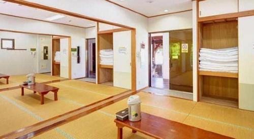 a room with a table and a room with mirrors at Nature Miraikan in Naha