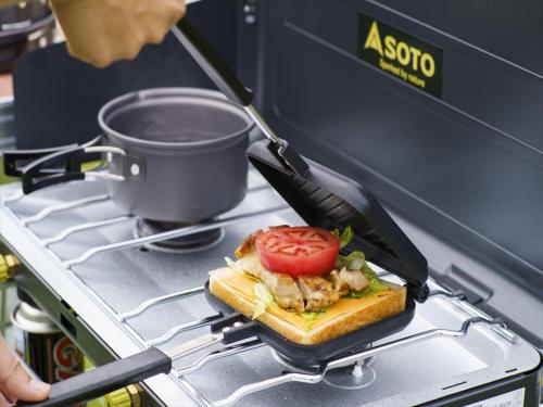 a person is cooking a sandwich on a stove at Nature Miraikan in Naha